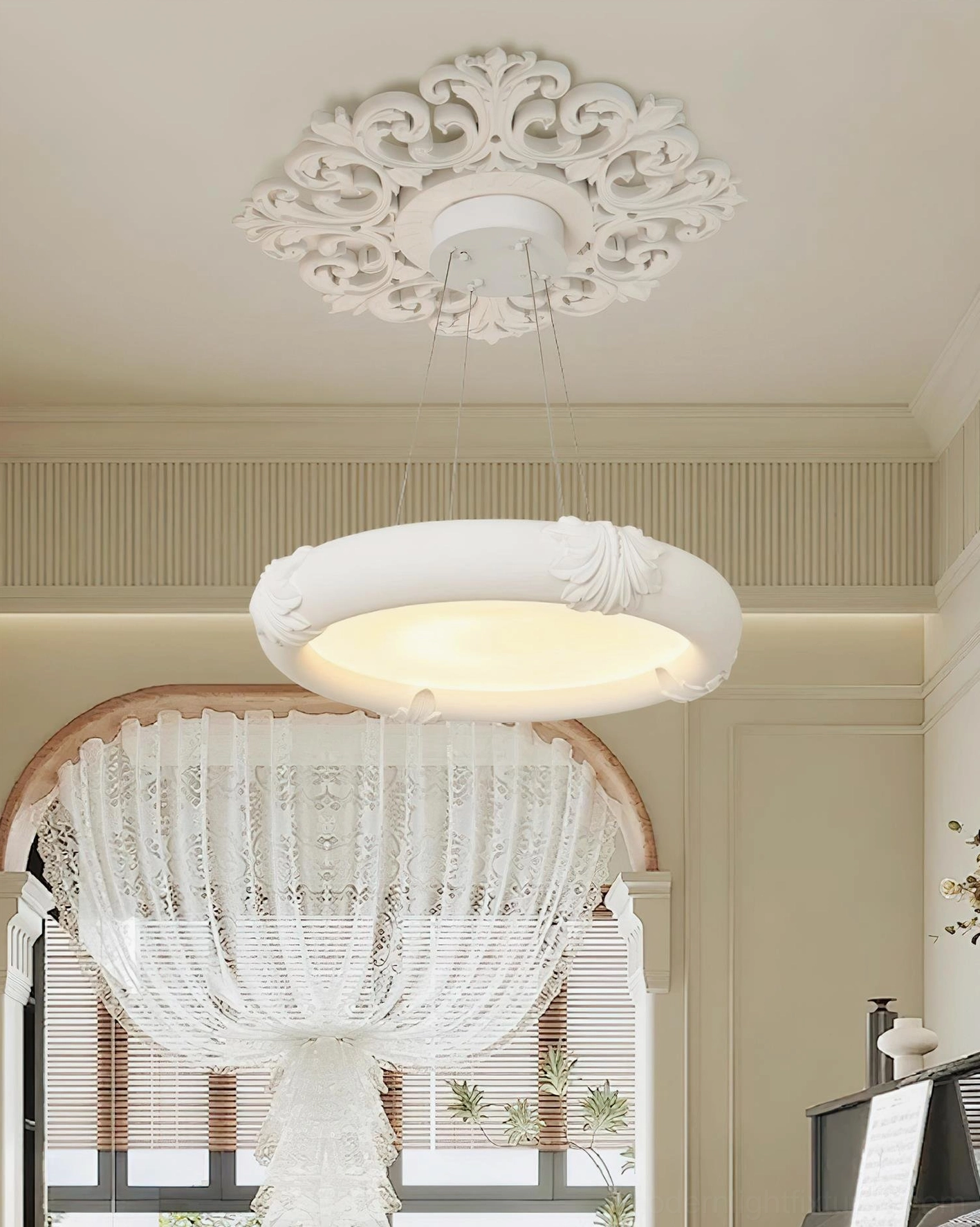 White plaster chandelier pendant in luxury interior with crown molding and arched window