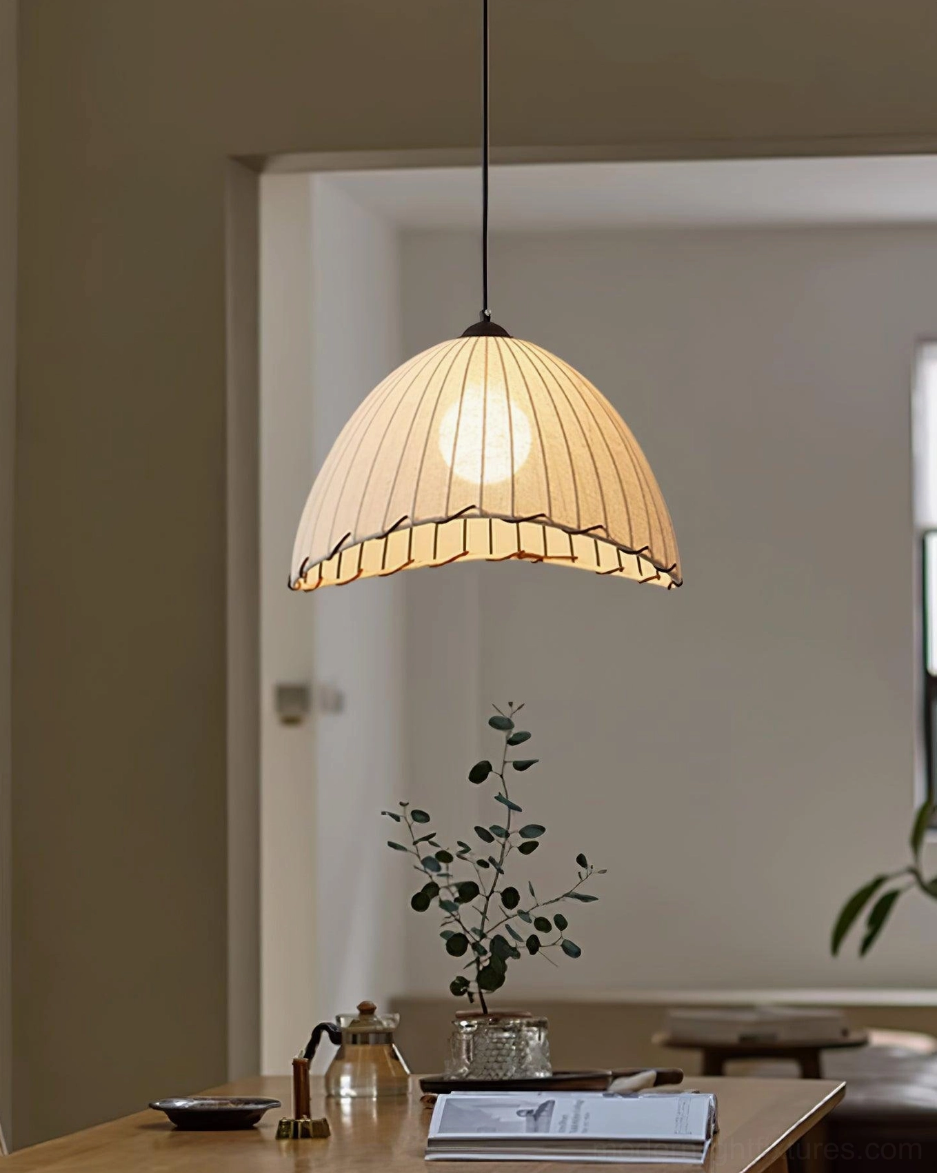 Contemporary pleated fabric pendant light creating warm ambiance in residential kitchen