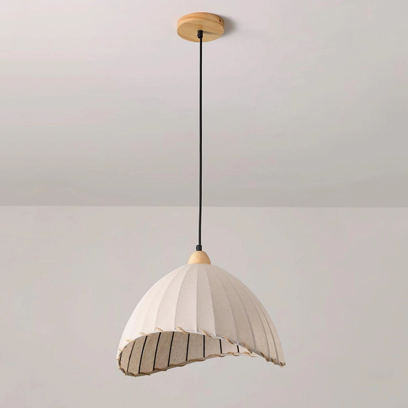 Maris pleated linen pendant light creating soft warm glow in cozy home interior
