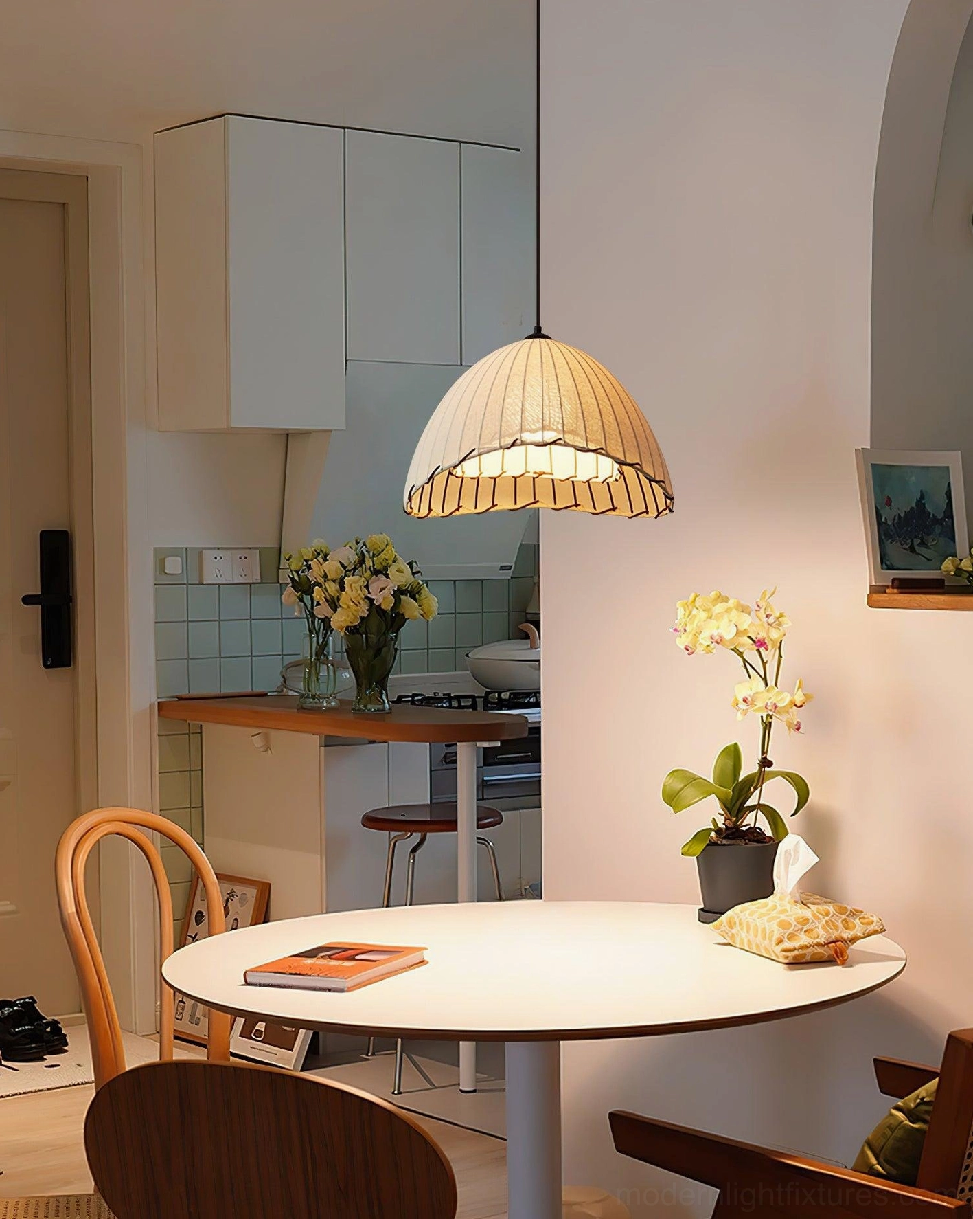 Maris pleated fabric pendant light illuminating studio apartment kitchen and dining combination