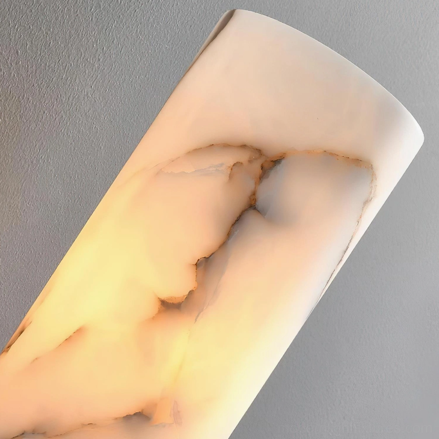 Luxury bedroom wall sconce with veined alabaster shade and two-tone metal hardware