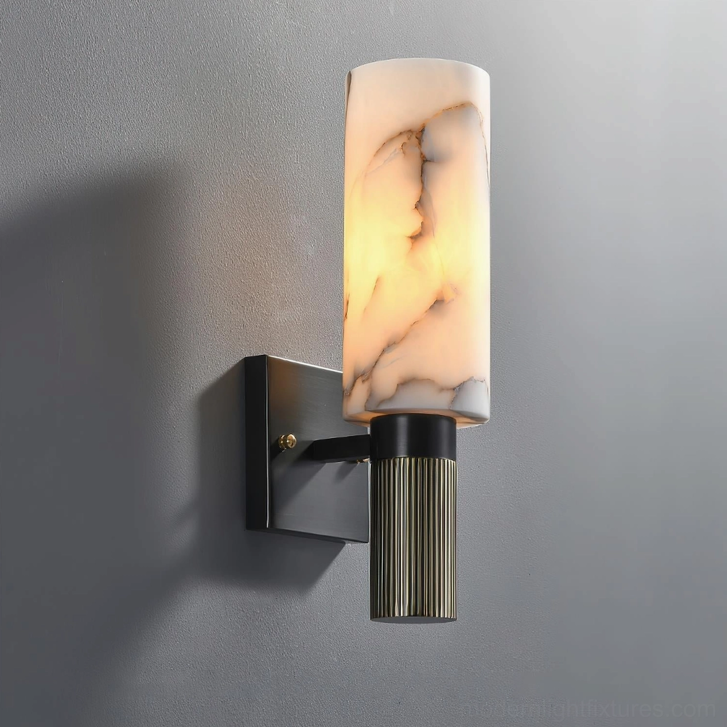 Side profile of cylindrical alabaster wall sconce with illuminated marble veining