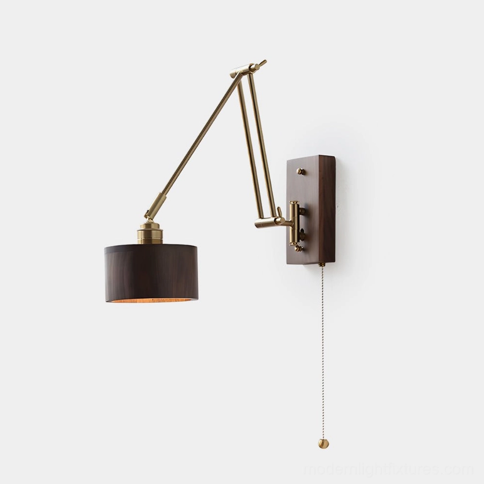 Marlow adjustable brass wall sconce with articulated swing arms in gold finish and walnut wood shade on plain white studio background