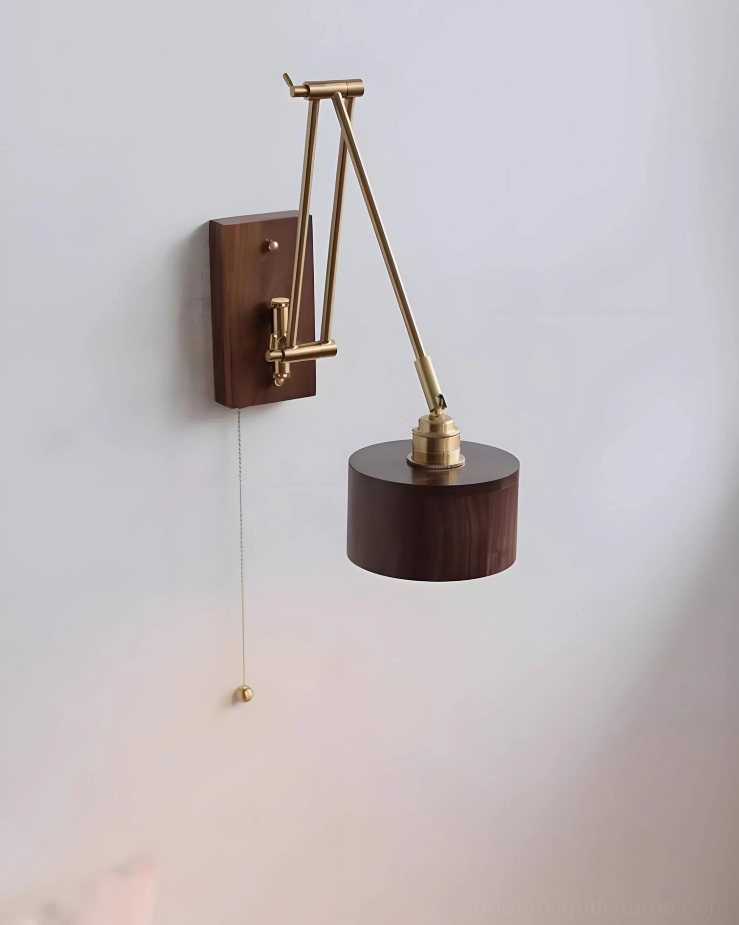 Adjustable brass wall sconce mounted on window wall with side view showing cylindrical wood shade and solid wood bracket