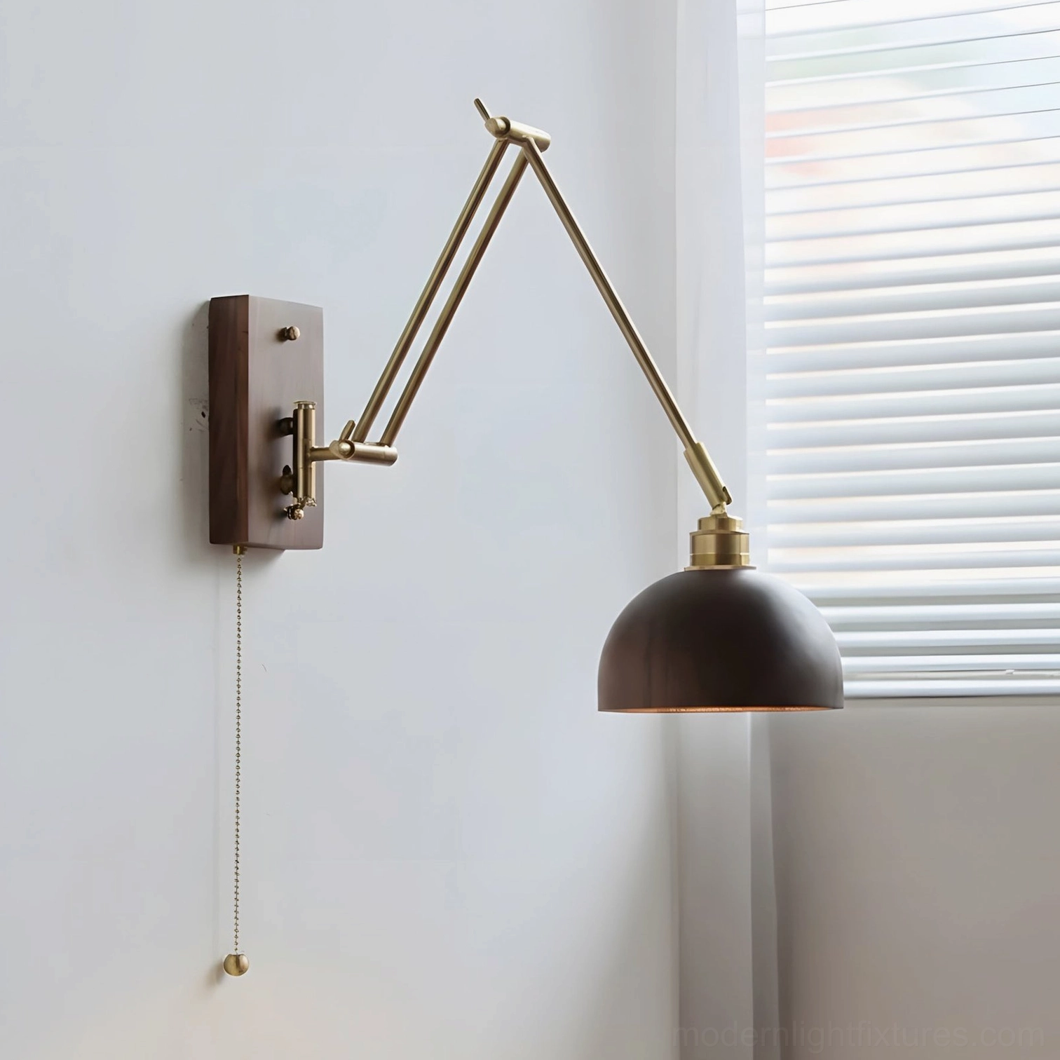 Model C adjustable swing arm wall sconce with brass articulation and dark wood shade demonstrating functional design