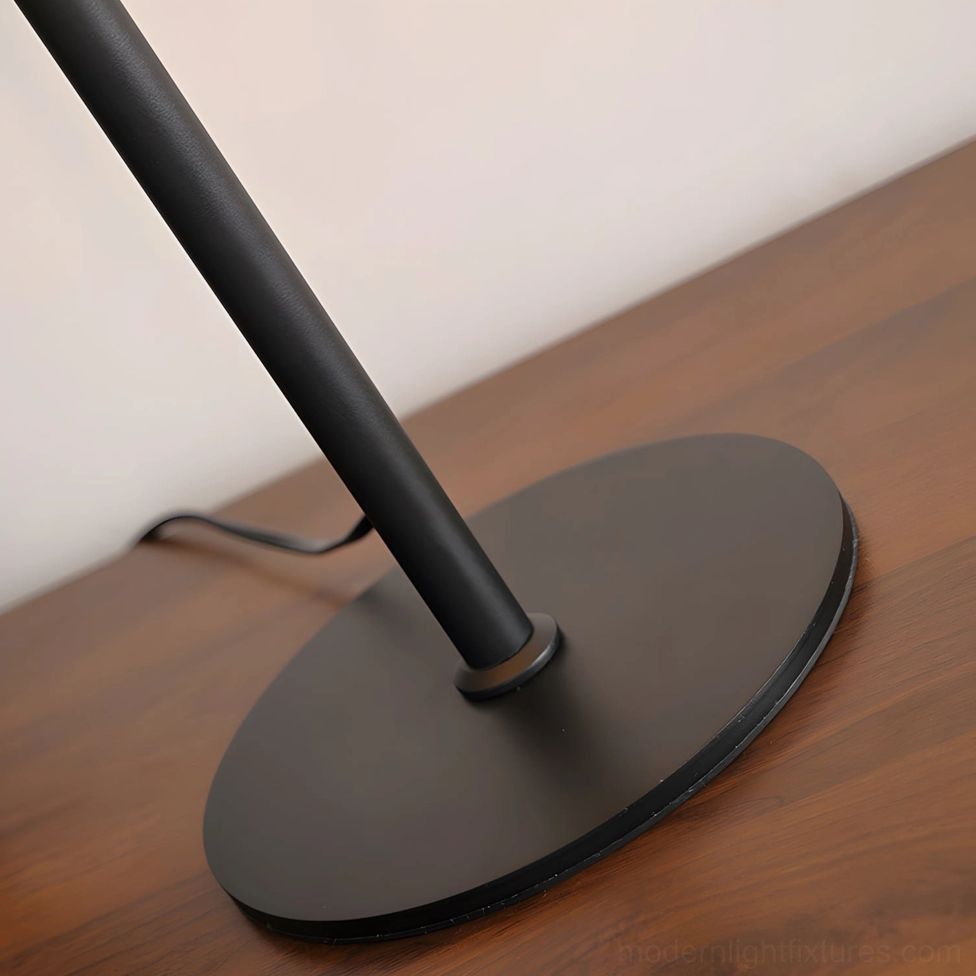 Marlow pleated leather table lamp architectural metal stem and weighted disc base detail on studio background