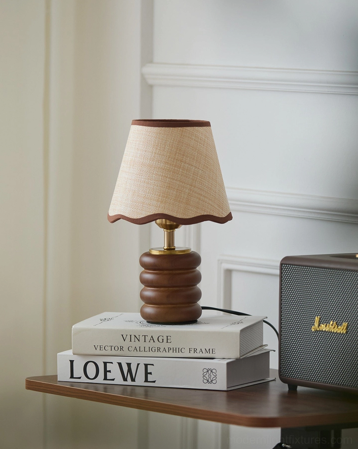 Marlowe small wood table lamp on side console with stacked decorative books and vintage speaker, modern home interior