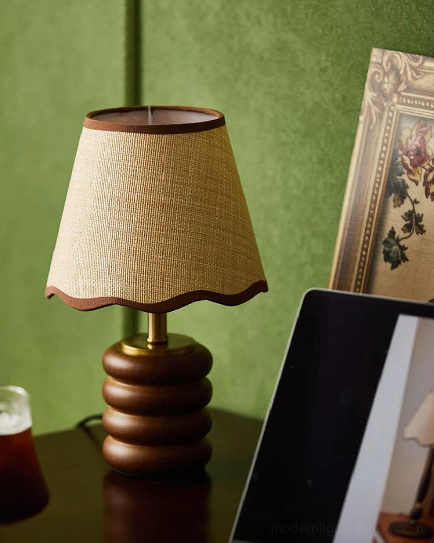Marlowe retro table lamp on wood desk beside green accent wall and framed floral artwork, mid-century home office