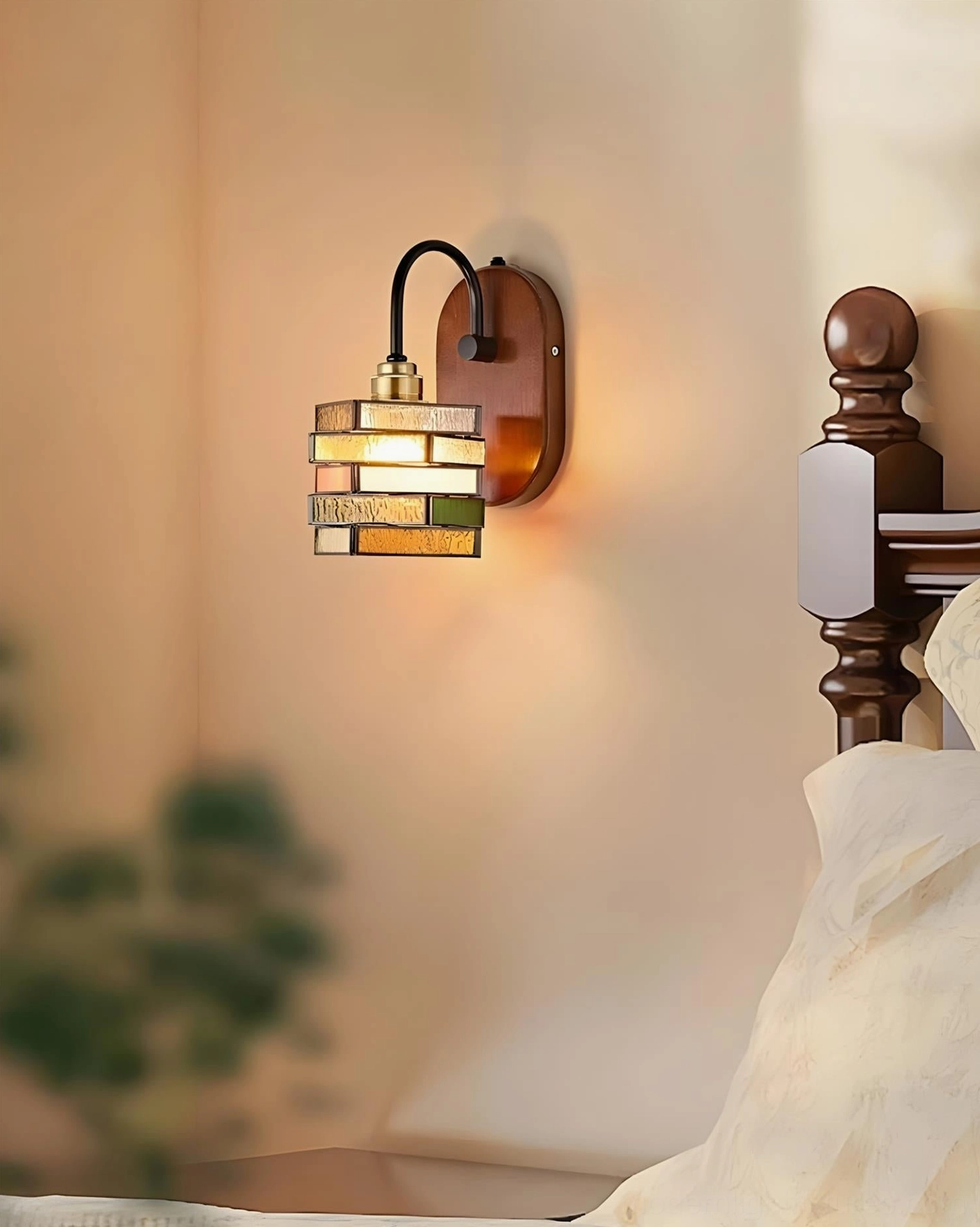 Cozy bedroom with Marlowe wall sconce beside wooden bedpost casting warm diffused light