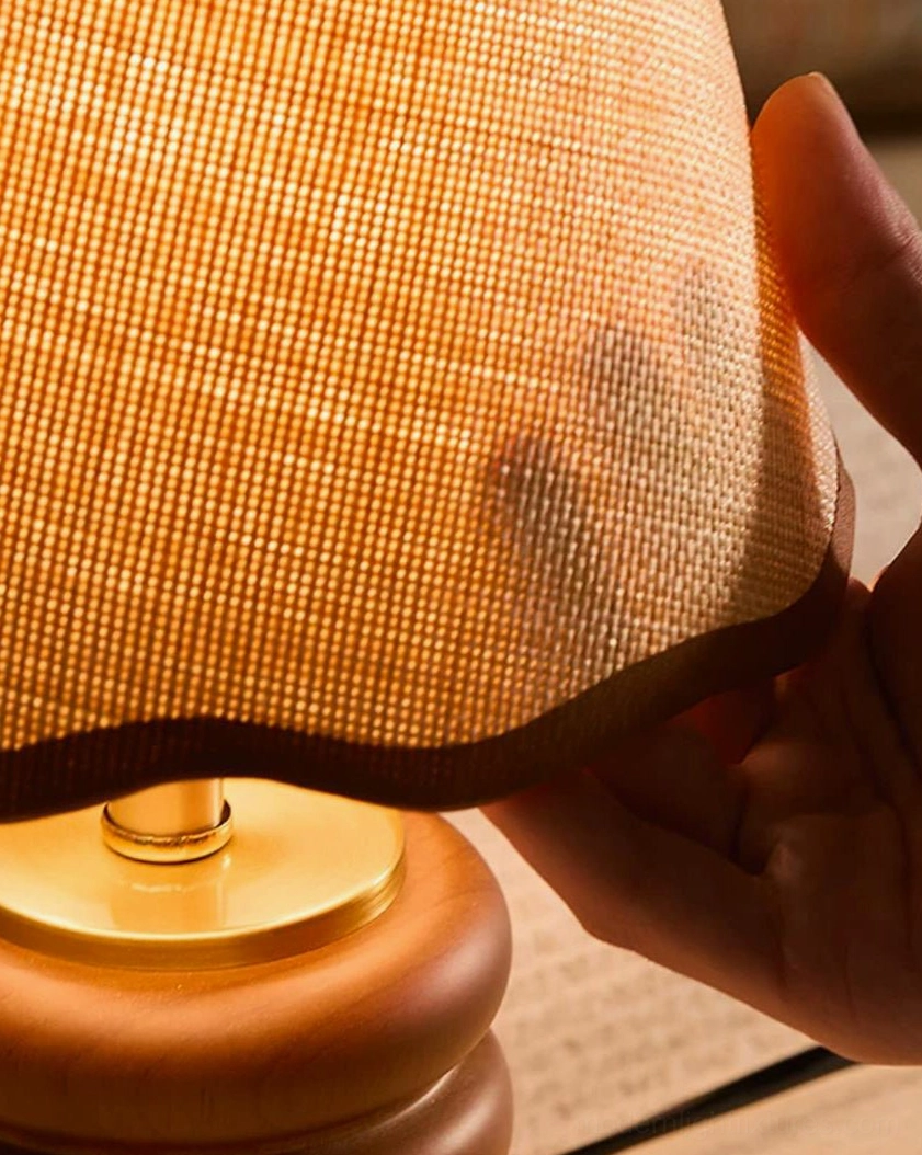 Marlowe walnut stacked-ring table lamp base with brass stem and woven fabric scalloped shade, three-quarter view