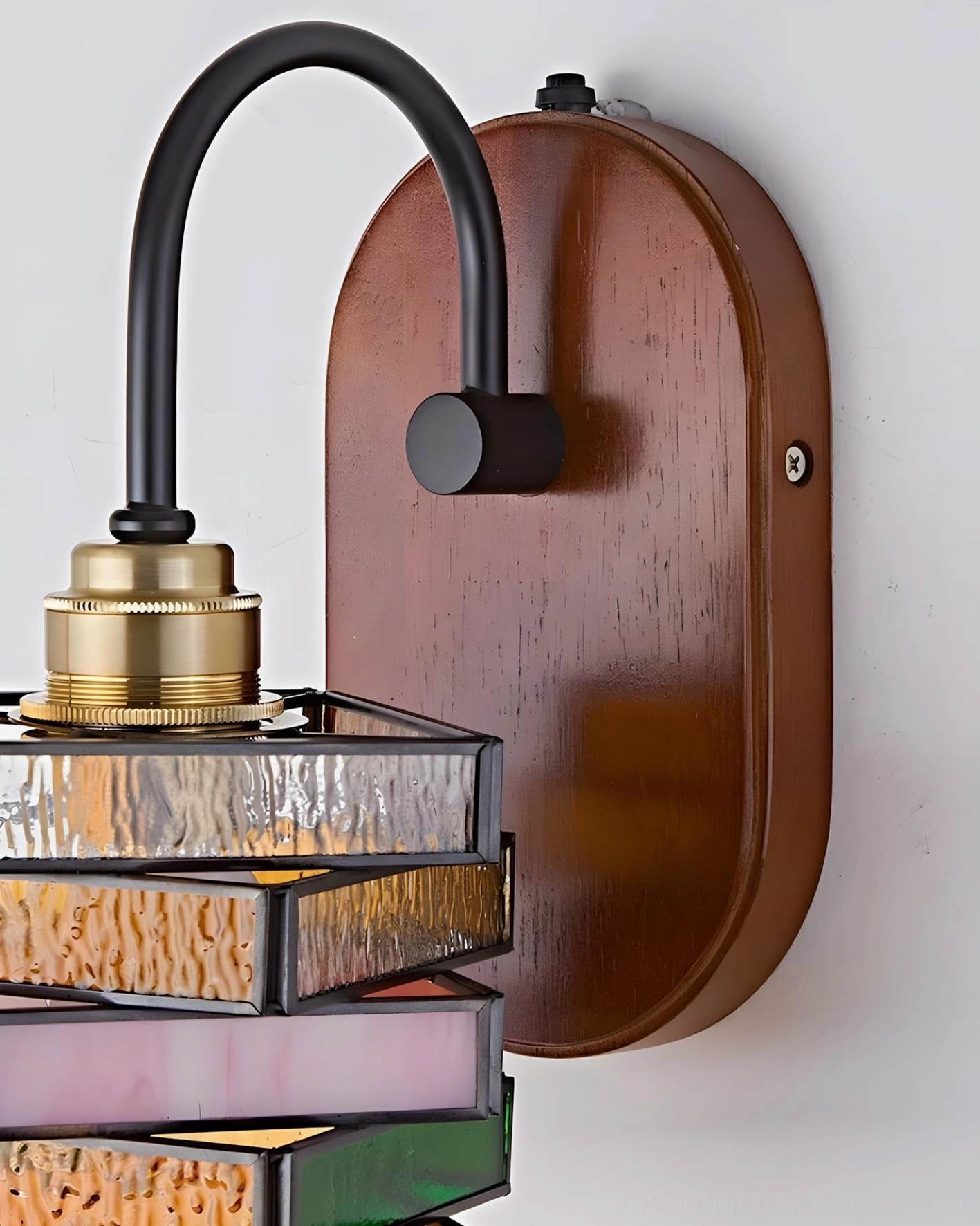 Marlowe vintage-inspired wall sconce detail showing curved metal arm and stained glass mosaic construction