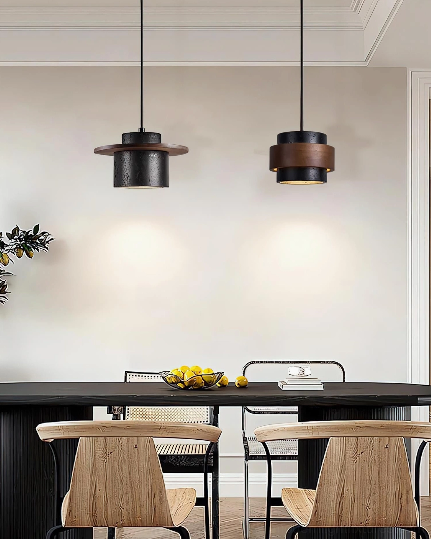 Three sculptural pendant lights in matte black and warm walnut tones over dark wood dining surface