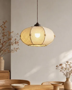Marova pendant light hanging in rustic dining room, warm ambient glow on natural wood table