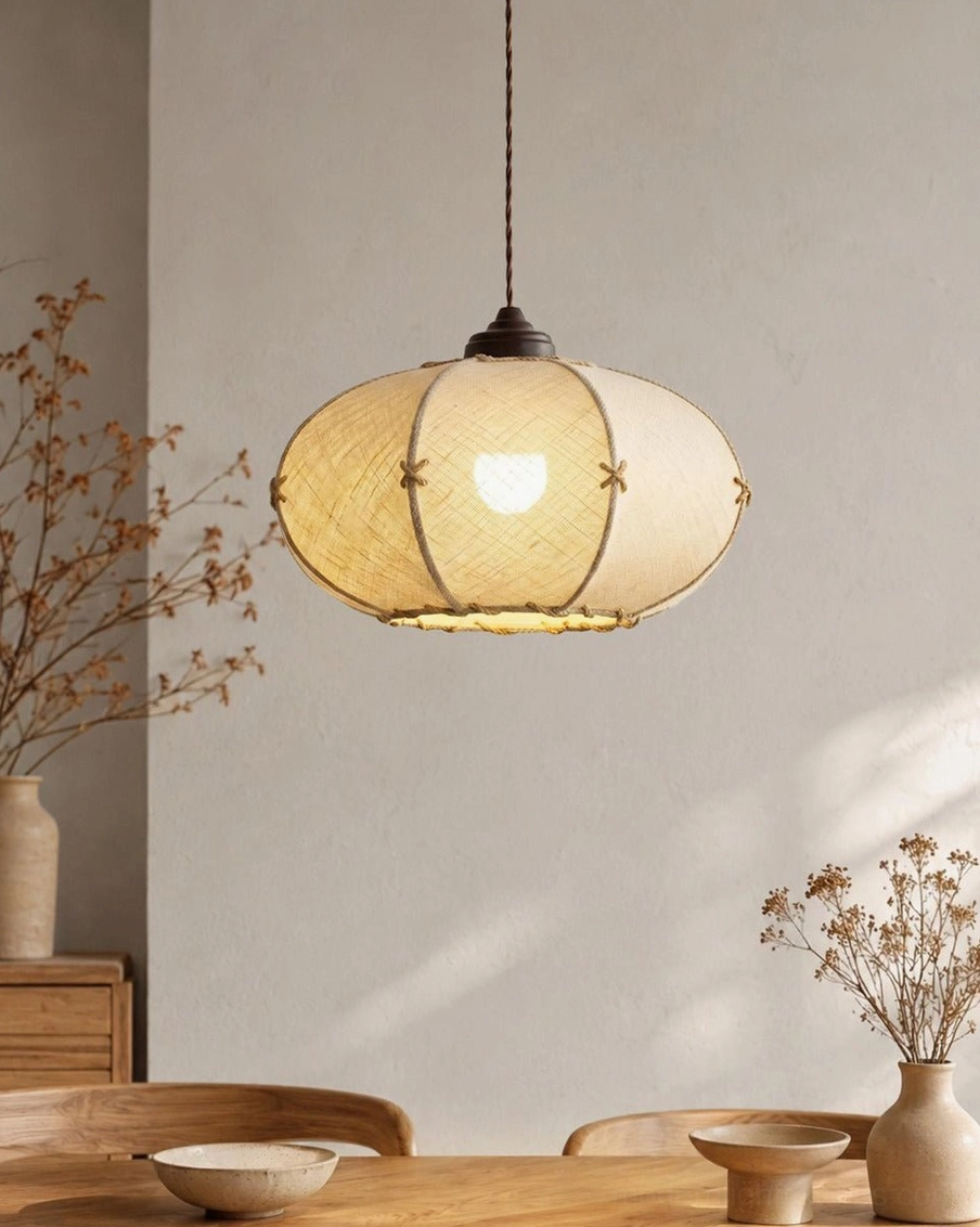 Marova pendant light hanging in rustic dining room, warm ambient glow on natural wood table
