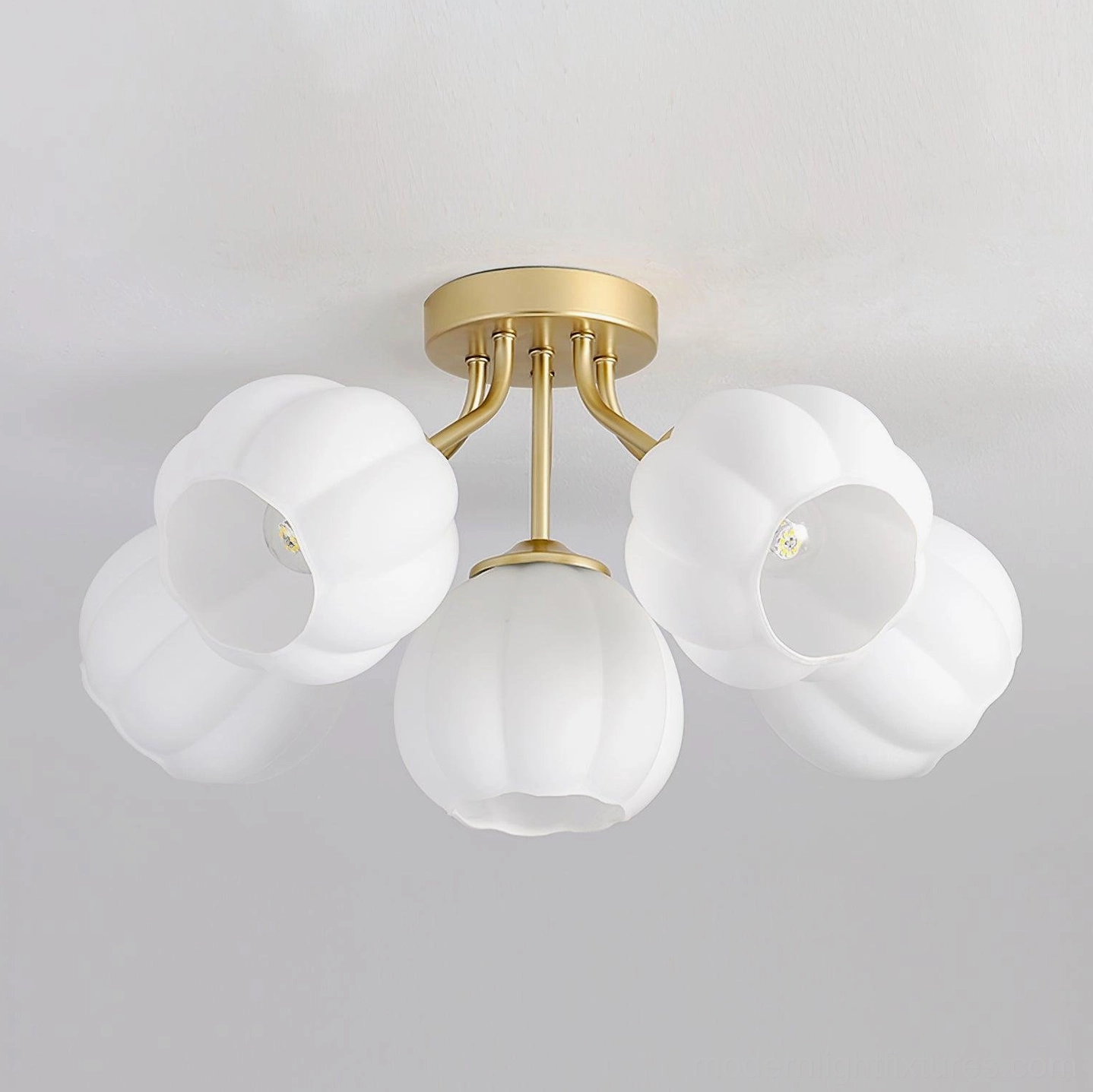Overhead shot of 5-head Marra ceiling light fixture showing brushed gold hardware and textured pumpkin-shaped white glass shades