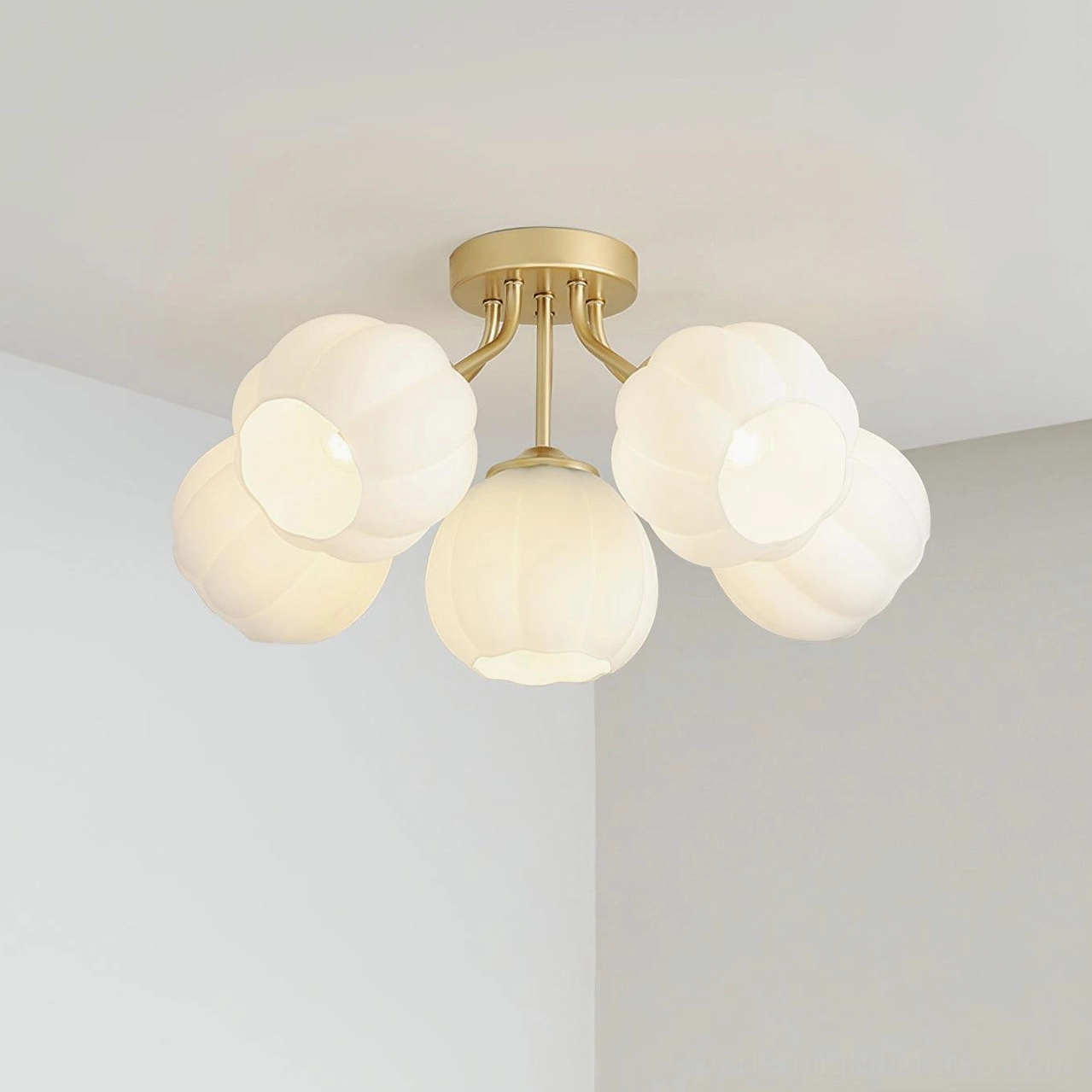 Low-angle view of 5-head Marra floral semi-flush ceiling light with brushed gold metal arms and unlit frosted glass shades