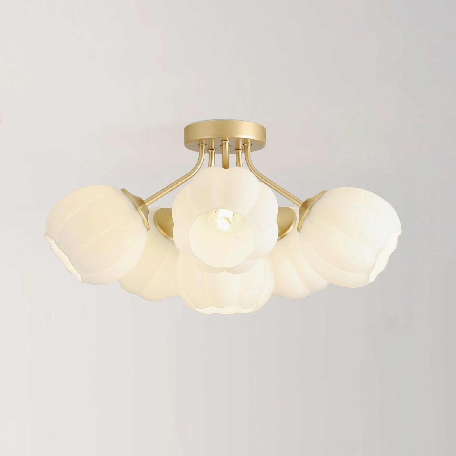 Overhead view of 6-head Marra floral ceiling light fixture showing lit frosted white pumpkin glass shades with brushed gold fixtures