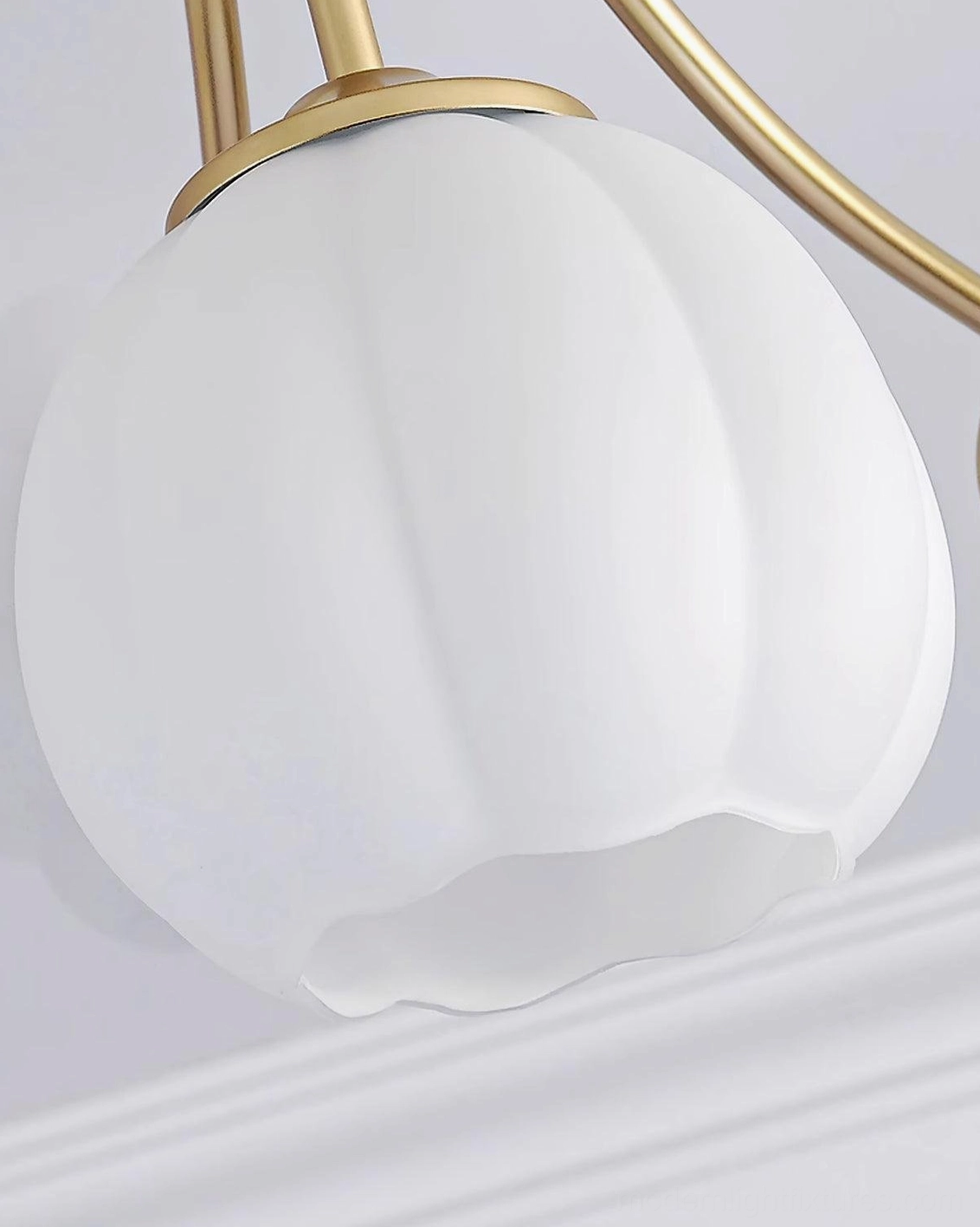 Marra floral semi-flush ceiling light fixture highlighting the delicate brushed gold metalwork and rounded frosted glass