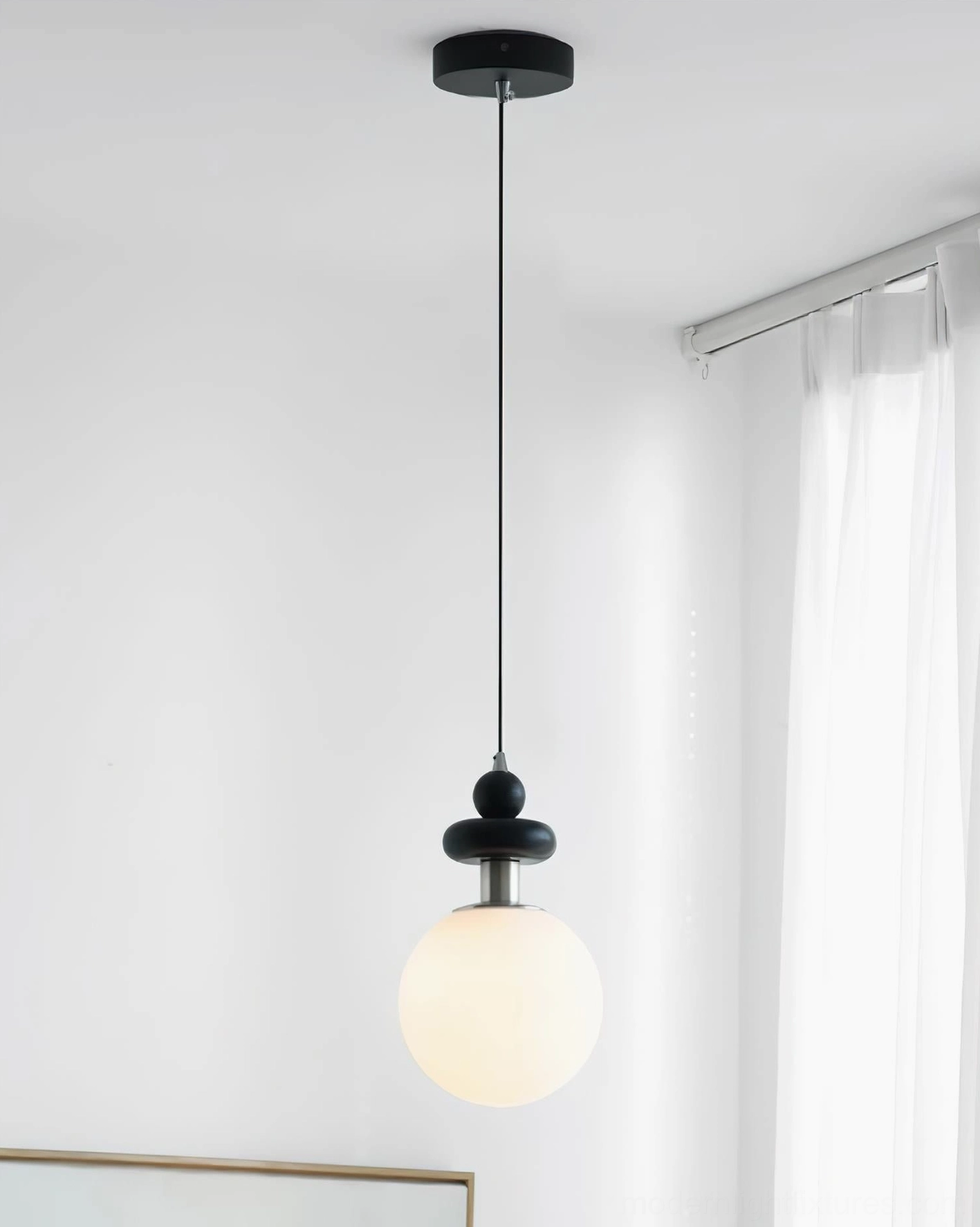 Marra Globe Pendant Light illuminated at night, showing soft frosted glass diffusion and modern geometric silhouette effect