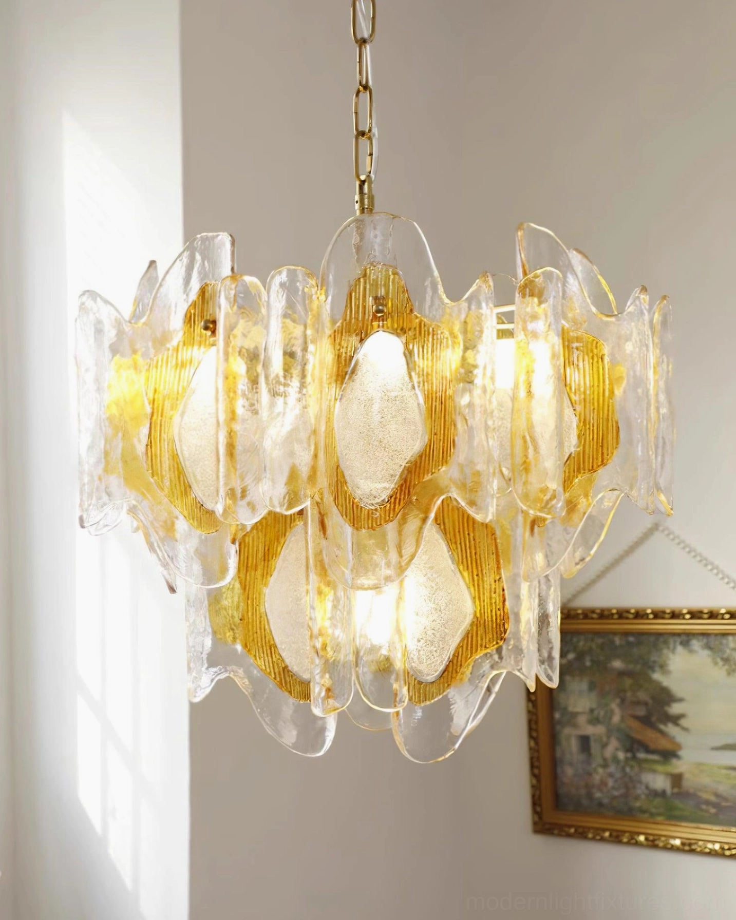 Hand-blown vintage glass chandelier with soft amber tone and golden brass mounting hardware