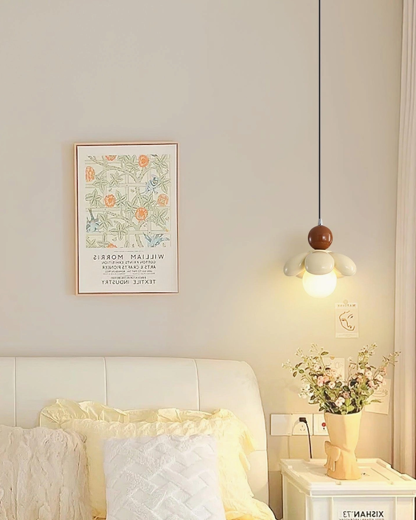 Beige Maru Flower Pendant Lamp above nightstand with decorative flowers, modern bedroom