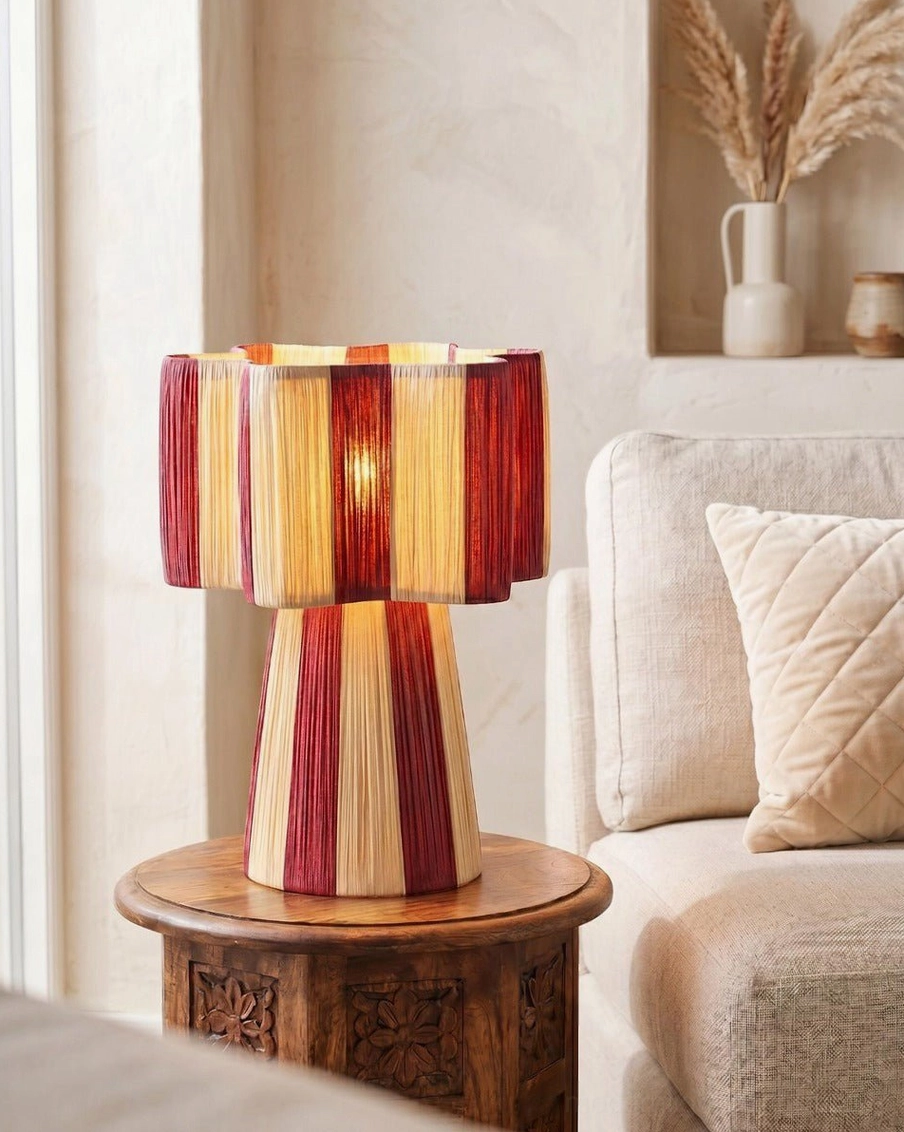 Maruvia cotton-cord lamp on carved wooden side table beside linen sofa in cozy living room setting, side profile view
