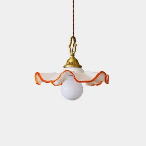 Marzelle ruffled glass pendant light with antique brass fitting and orange rim, frontal view studio display