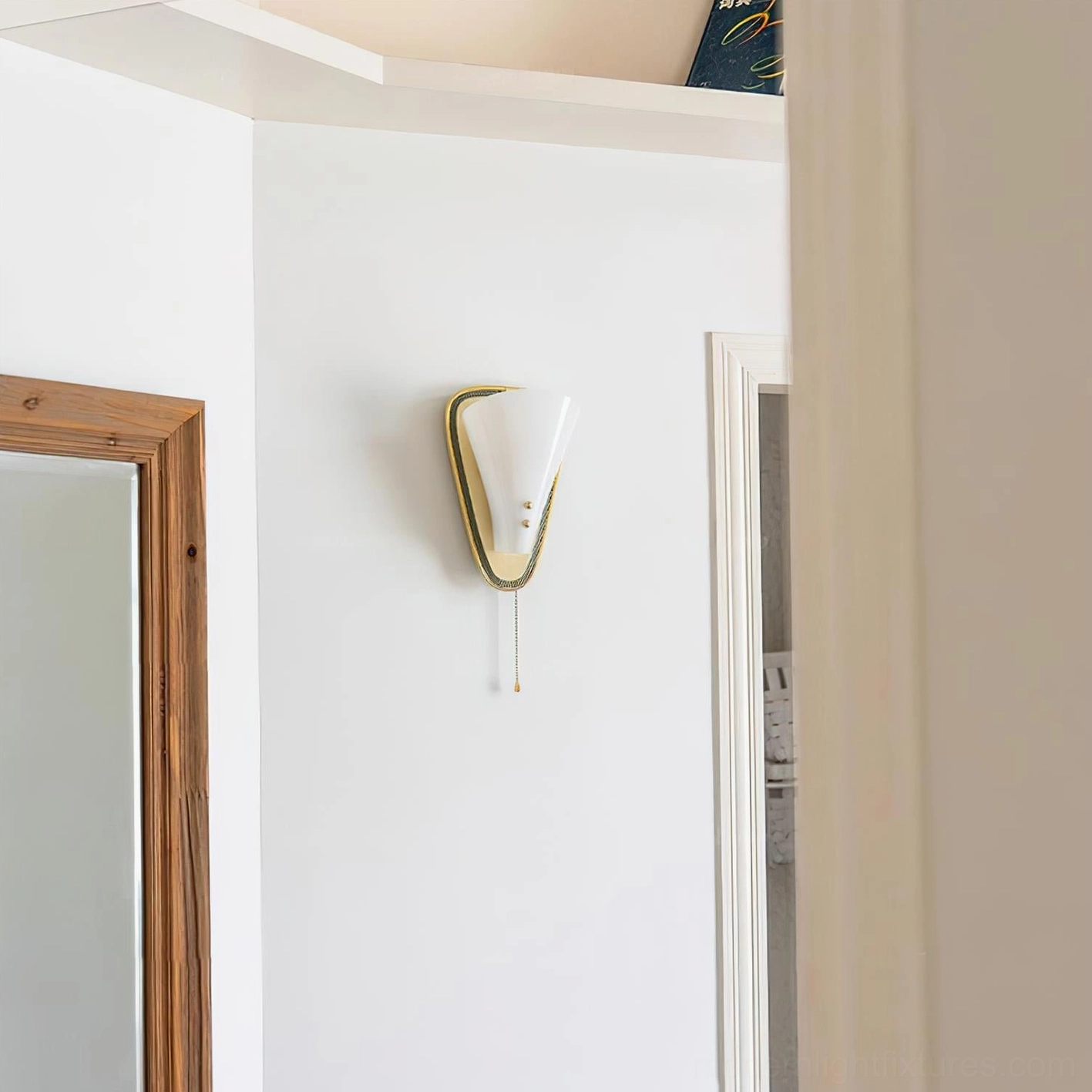 Marzio mid-century modern wall sconce mounted in residential interior showing compact gold frame design