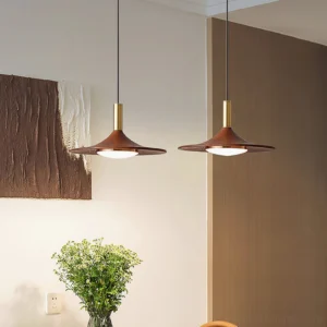 Pair of walnut pendant lights with gold hardware in minimalist dining room setting