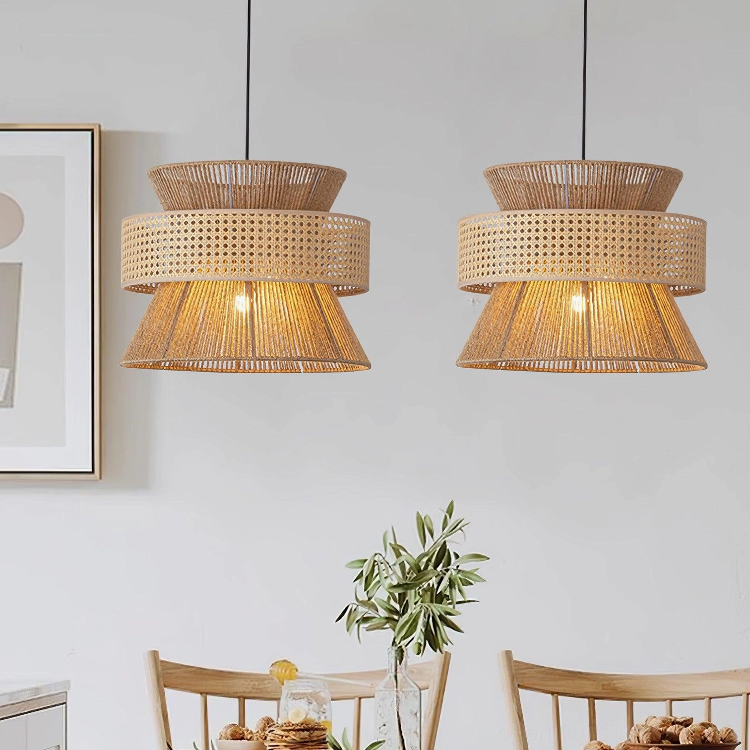 Pair of matching natural rattan pendant lights with layered shades in modern dining room