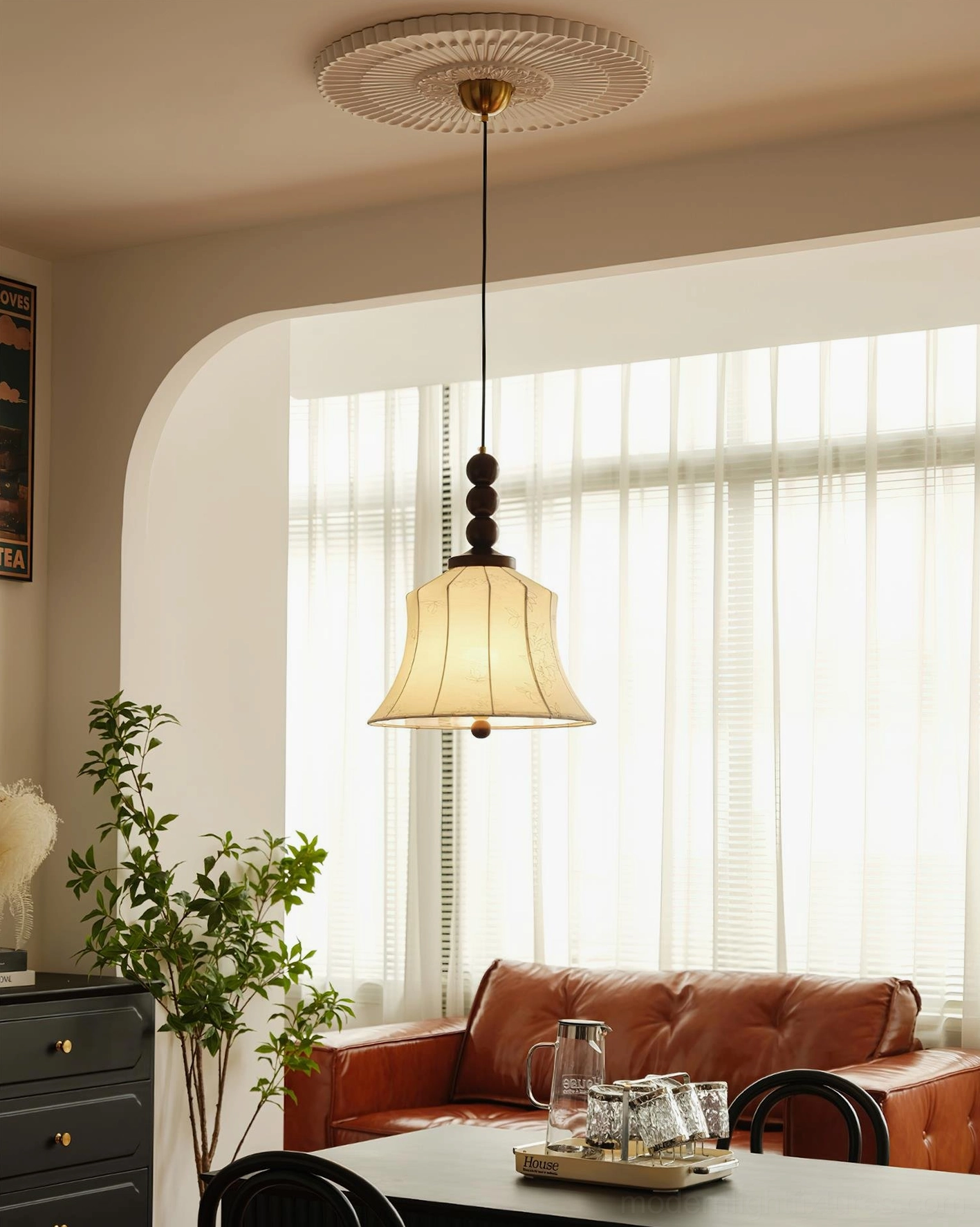 Materia fabric pendant lamp over dining area with brown leather sofa, warm cream shade with dark wood suspension