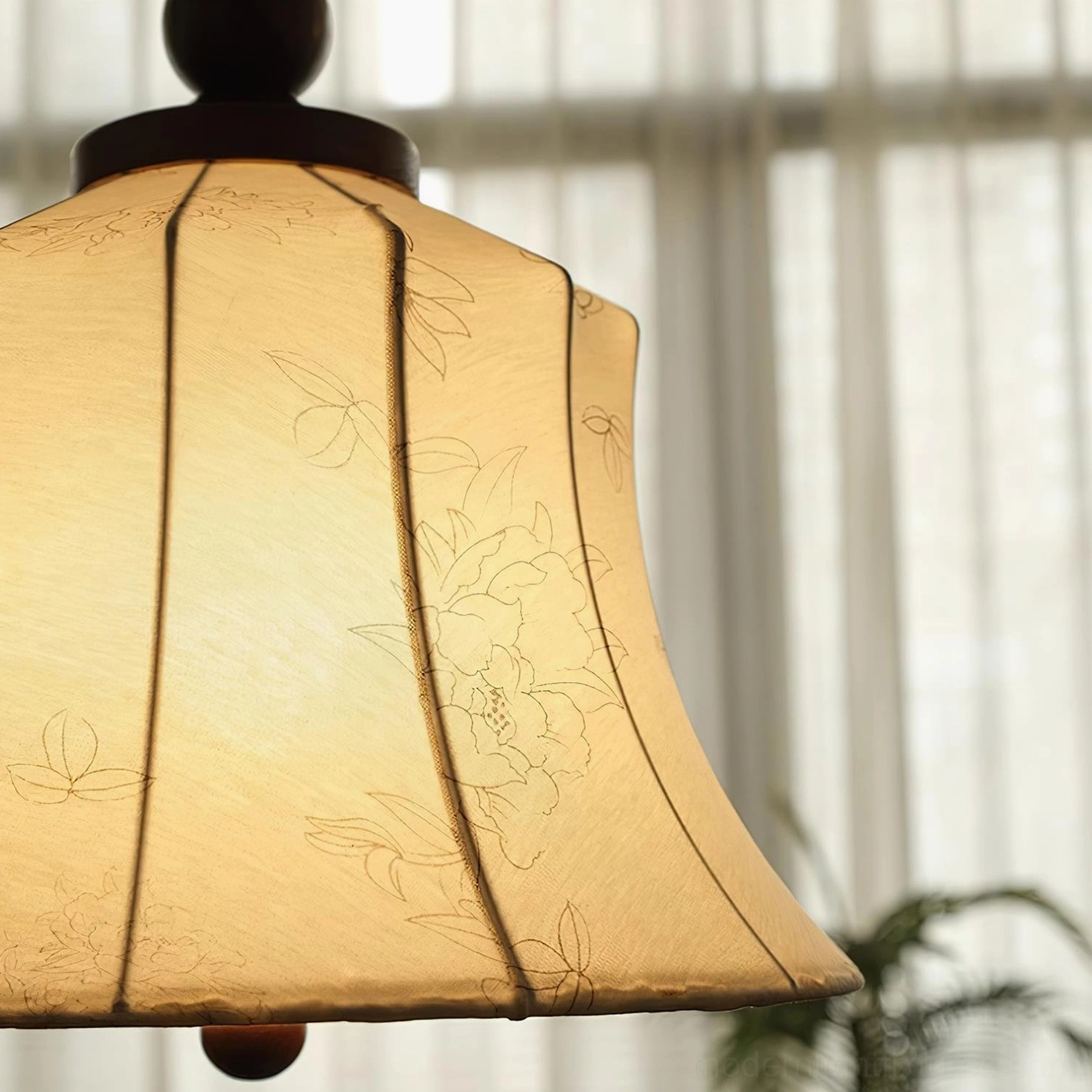 Materia fabric pendant light creating ambient glow in contemporary interior with decorative furnishings
