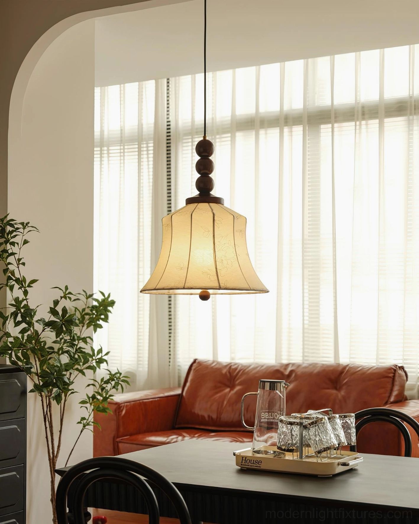 Materia pendant light in retro dining room setting with wooden table and vintage leather furniture