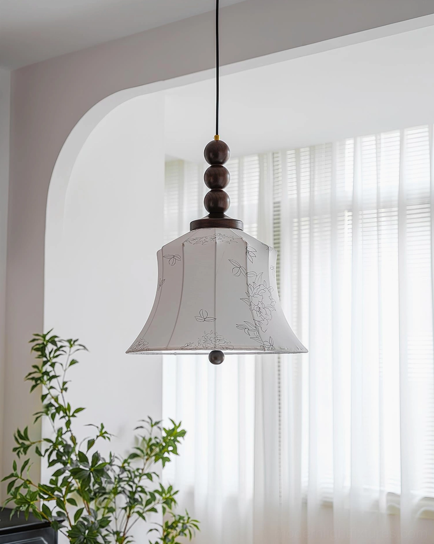 Materia hanging pendant lamp in minimalist interior with arched doorway, showing warm ambient lighting