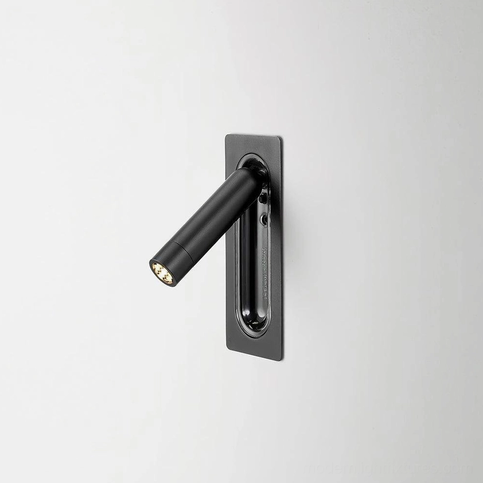 Matte black recessed LED wall lamp detail showing integrated light source and smooth rotation capability for bedside use