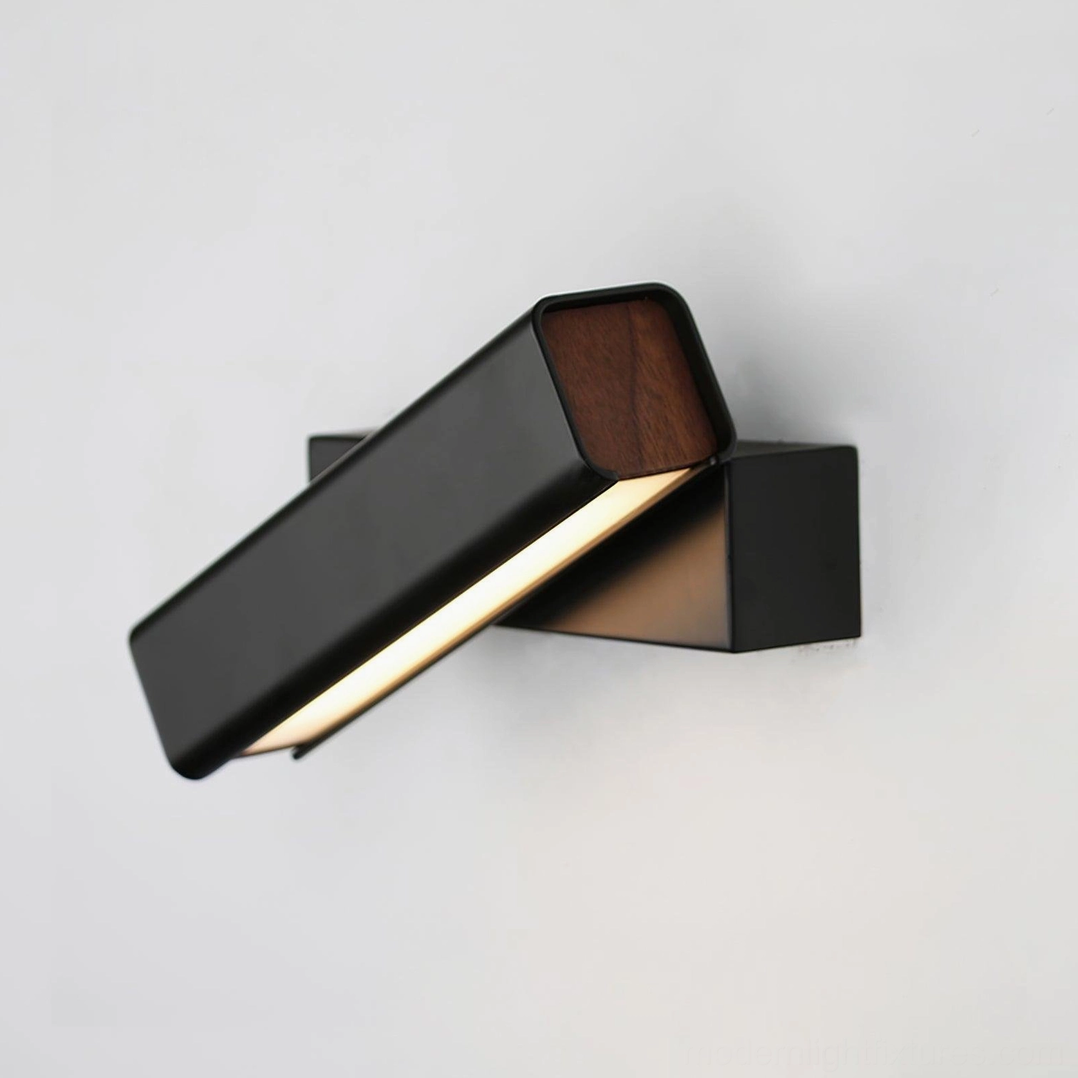 Matte black Nordic wall sconce mounted as bedside reading light with warm white color temperature