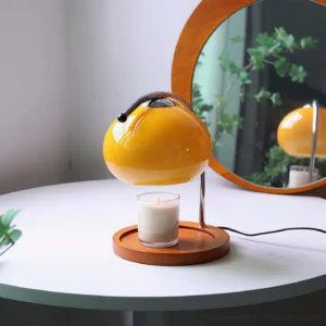 Mauri halogen candle warmer lamp displayed on white round side table with wall mirror, three-quarter side view showing warm glow
