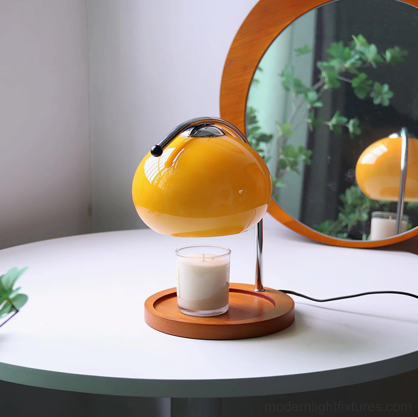 Mauri halogen candle warmer lamp displayed on white round side table with wall mirror, three-quarter side view showing warm glow