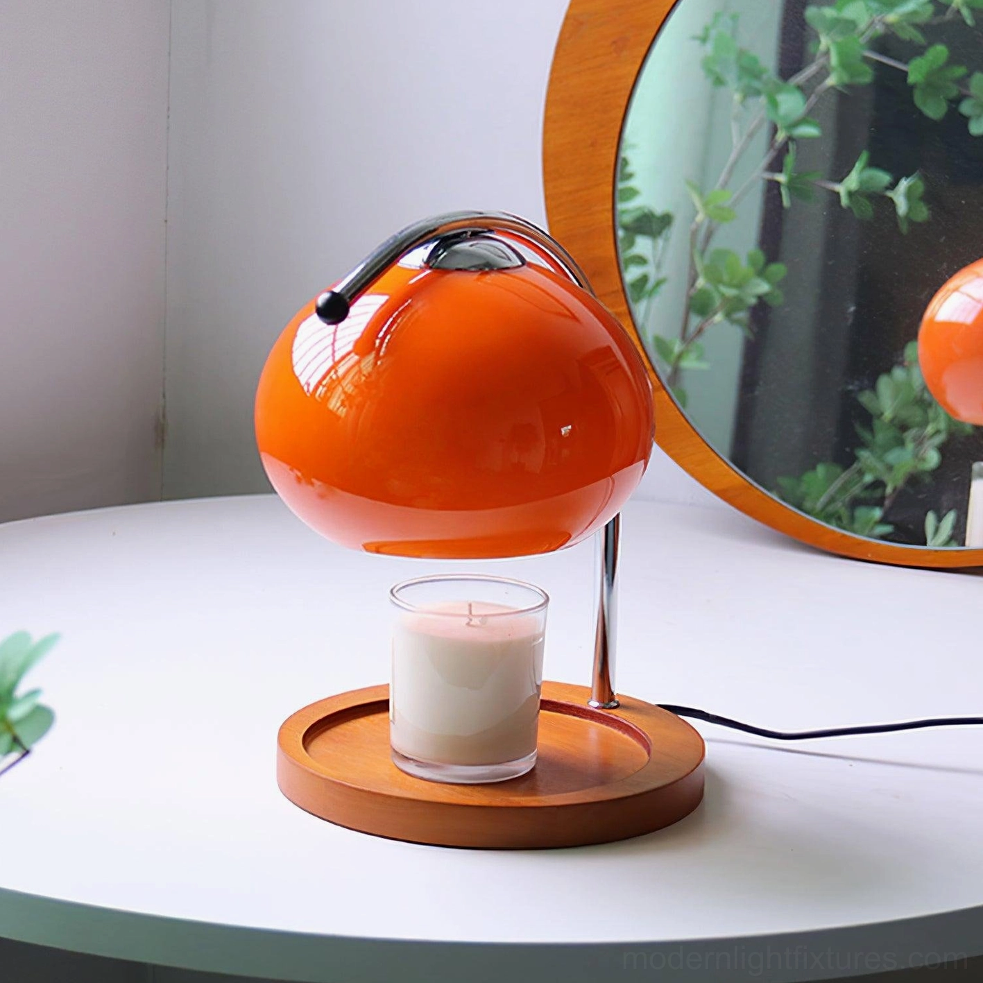 Mauri halogen candle warmer lamp with bright orange shade and lit unscented candle on base, vibrant statement lighting