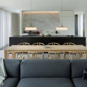 Pair of Maxim pendant lights in contemporary dining kitchen space, warm ambient lighting