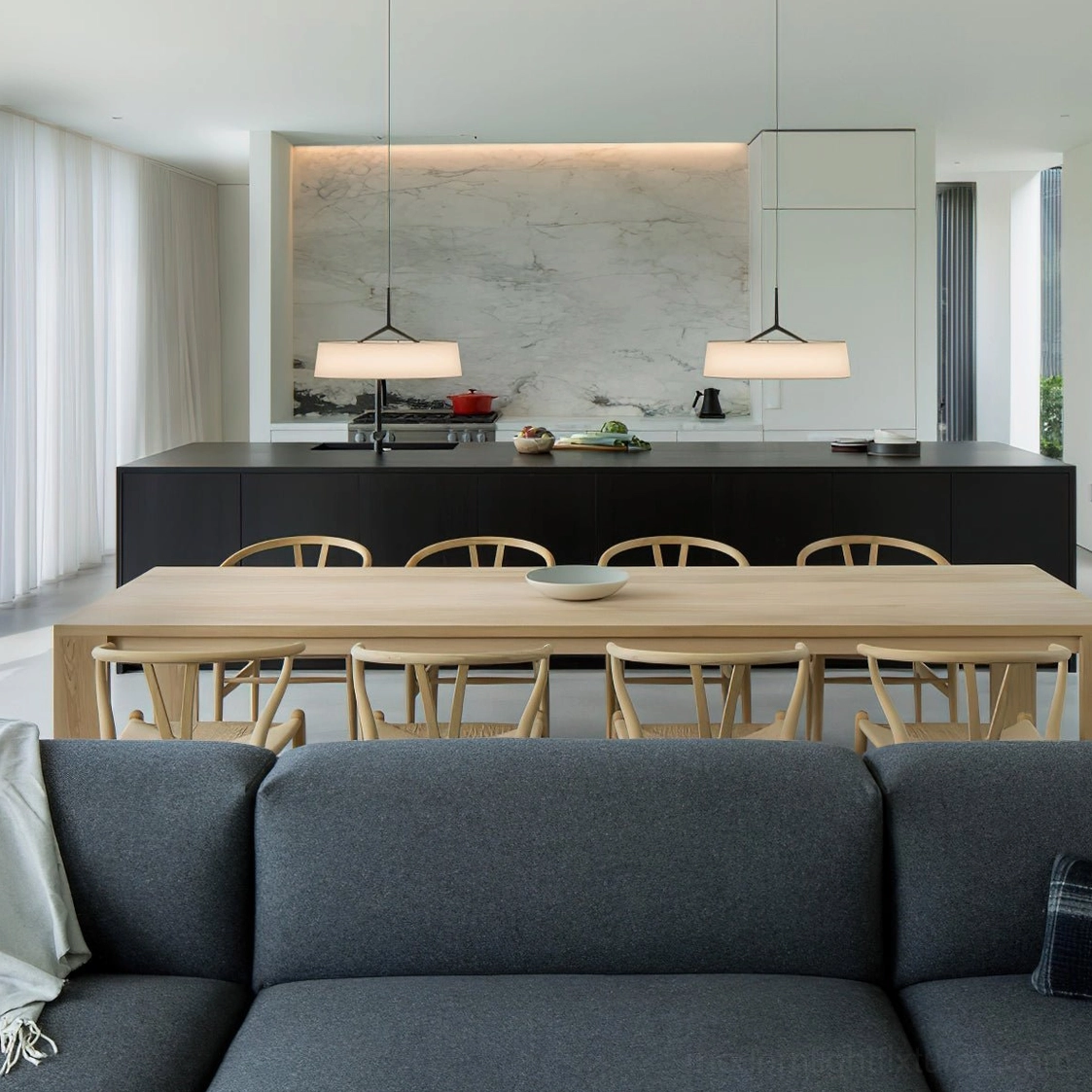 Pair of Maxim pendant lights in contemporary dining kitchen space, warm ambient lighting