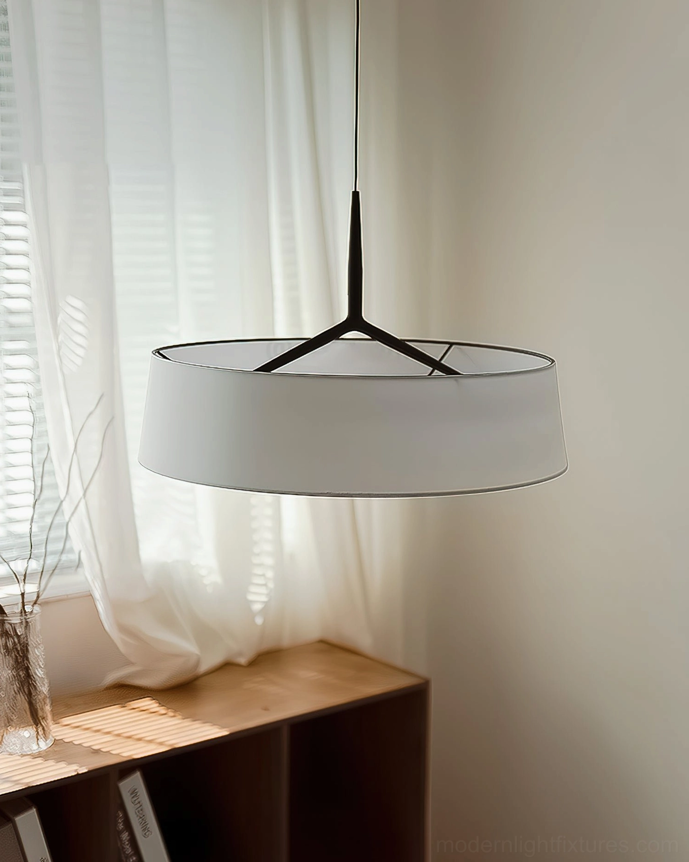 Maxim pendant lamp with light grey fabric shade in window corner with sheer curtain backdrop