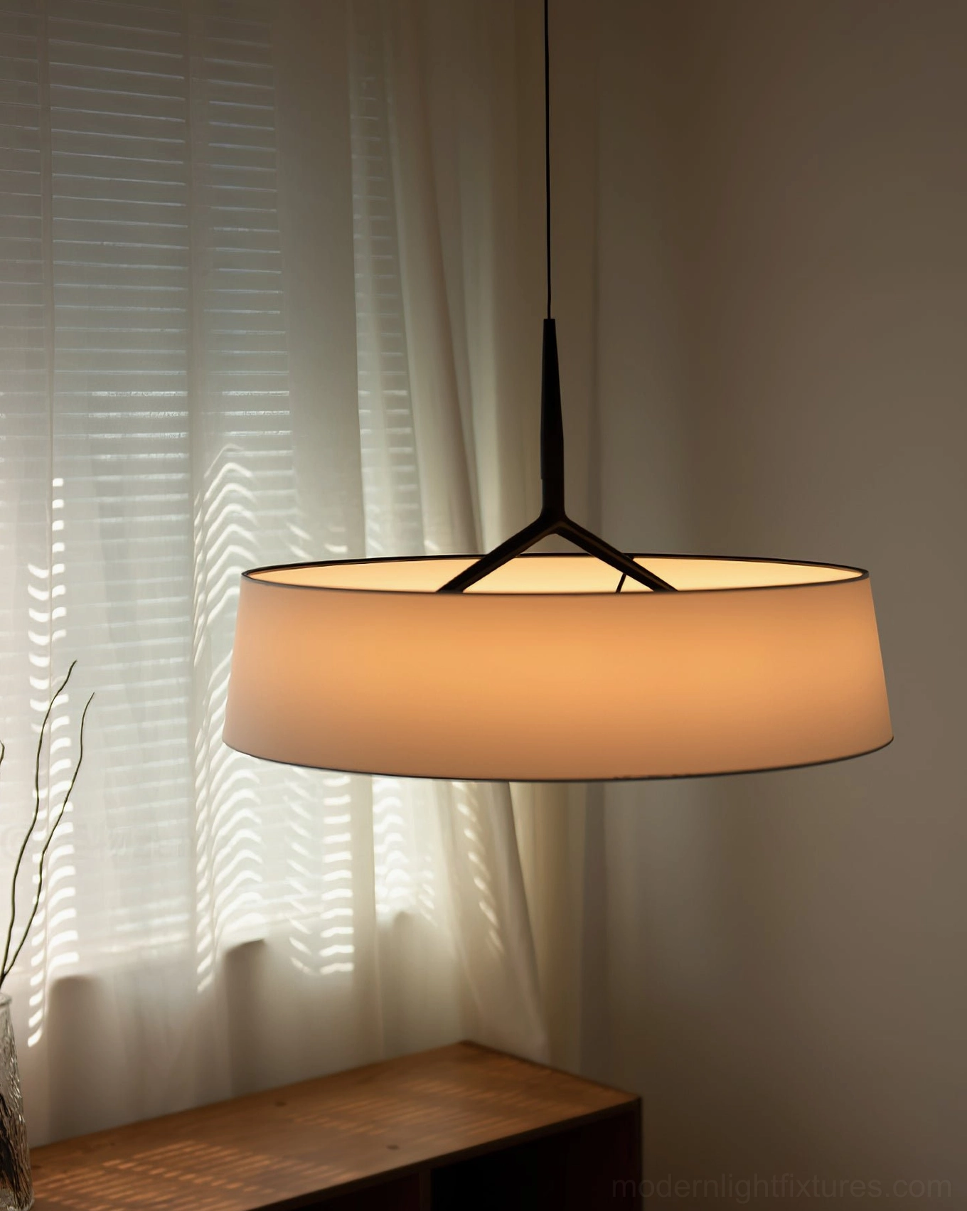 Maxim pendant light with amber fabric shade in window corner, residential interior photography