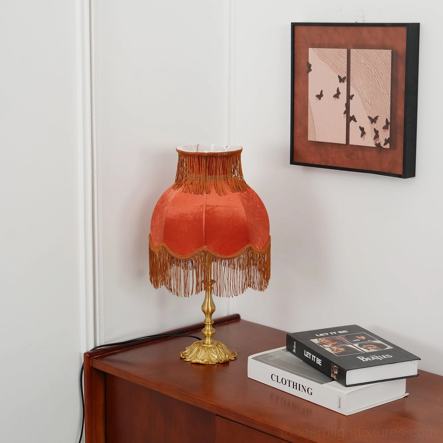 Maximalist tassel table lamp with luxurious velvet shade and brass base close-up