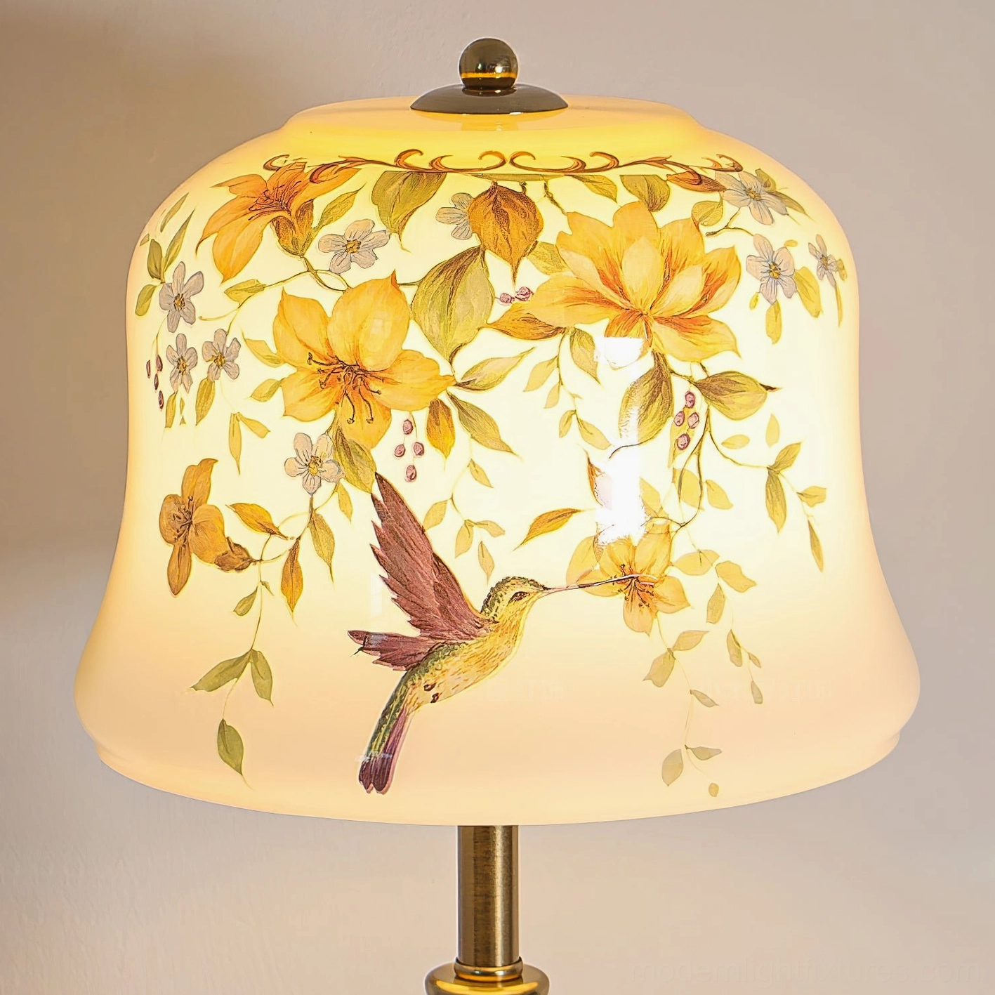 Close-up detail of Meadow lamp shade showing intricate hand-painted floral and hummingbird artwork illuminated