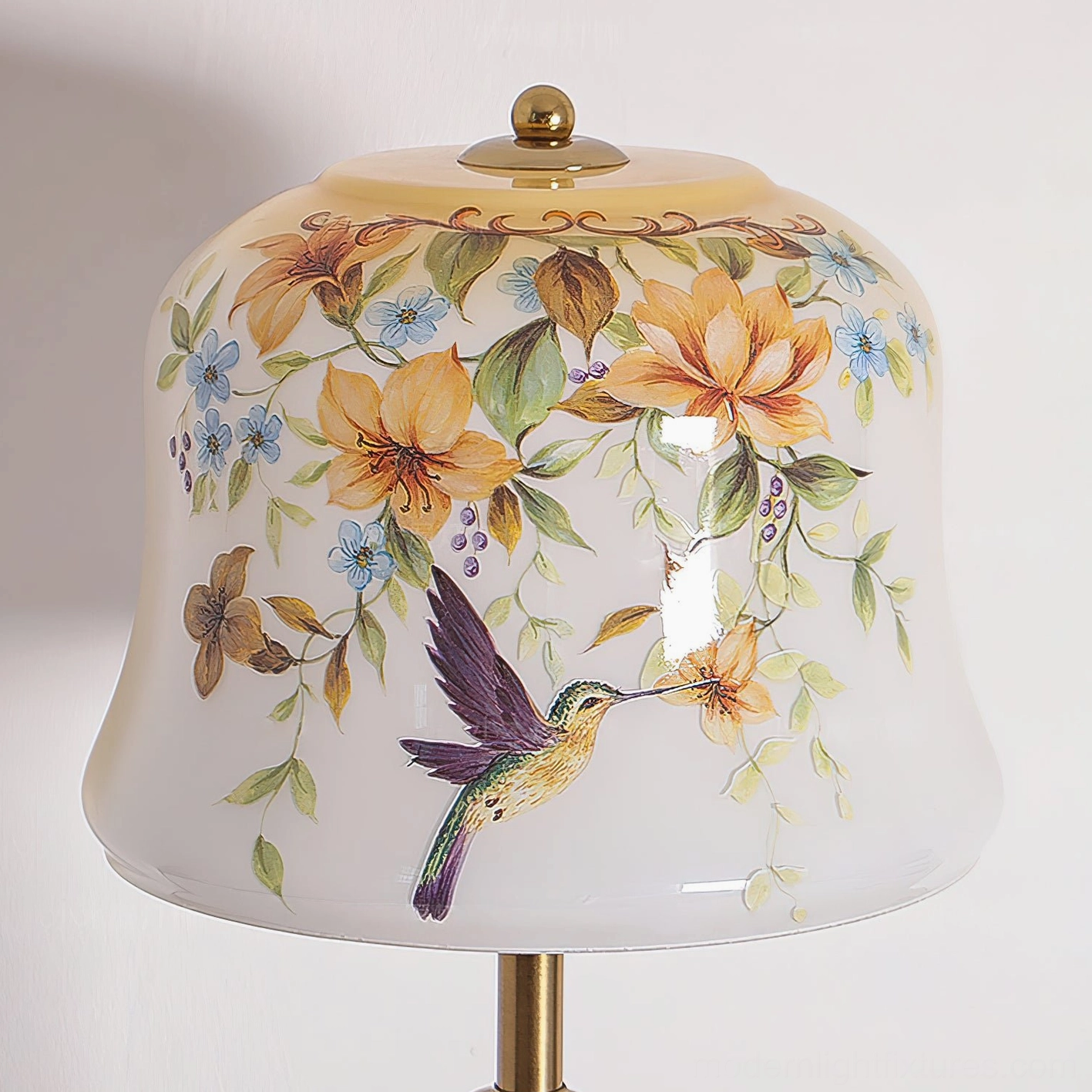 Close-up view of Meadow table lamp glass shade featuring detailed botanical floral design and hummingbird illustration