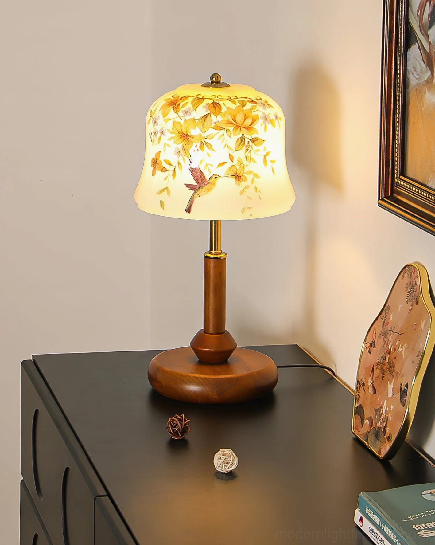 Side angled view of lit Meadow lamp showcasing soft yellow floral shade design with warm illumination and decorative elements