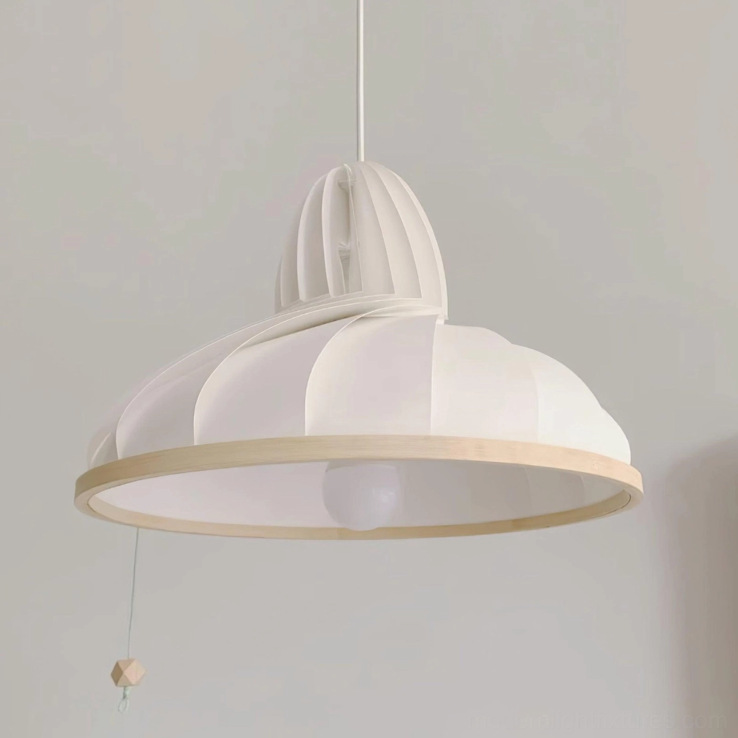 Off-white Meblo wave pendant light close-up front view with pull cord switch and wooden base trim detail on studio background