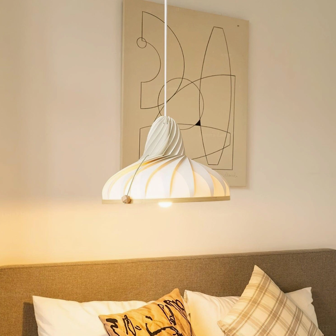 Modern Meblo pendant light hanging in living room corner with warm ambient lighting and abstract wall art, side profile showing ribbed texture