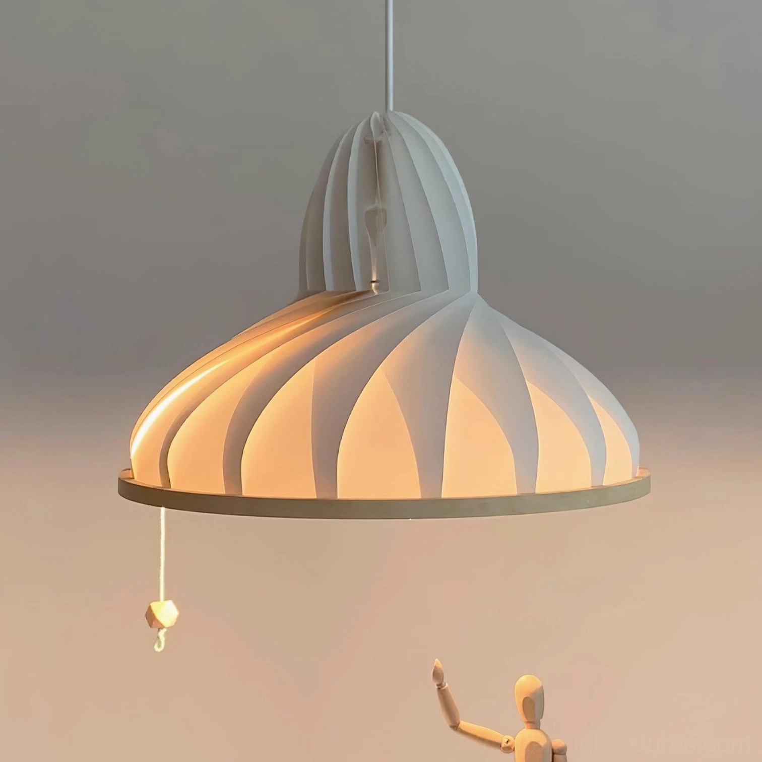Meblo wave pendant light with pull switch in warm glowing low-angle view, wooden decorative accessories nearby showing ambient lighting effect
